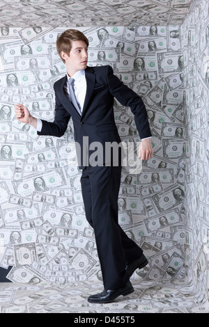a businessman running away from a dollar room Stock Photo - Alamy