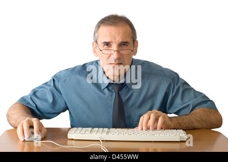 The man in spectacles intently looks in the computer monitor Stock Photo