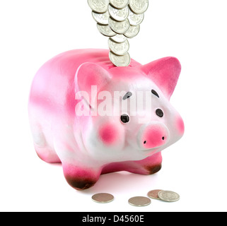 The money box as a pink pig stands on a white background