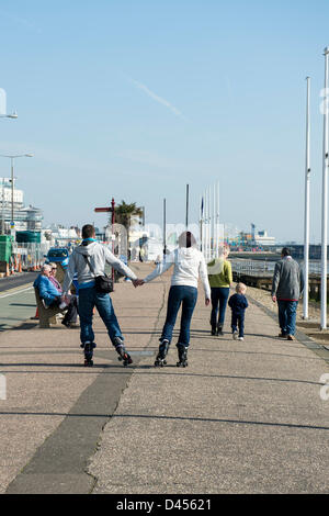 Southend, Essex, UK. 5th March 2013. People enjoy the unseasonably warm day. A young couple roller skate along Southend seafront while holding hands.  Credit:  Allsorts Stock Photo / Alamy Live News Stock Photo