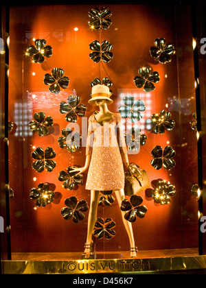 Womens fashion designer luxury boutique illuminated window display Louis Vuitton Via Montenapoleone Milan Lombardy Italy Europe Stock Photo