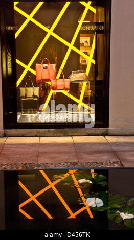 Giorgio Armani boutique designer store illuminated window display and reflection Via Montenapoleone Milan Lombardy Italy Europe Stock Photo