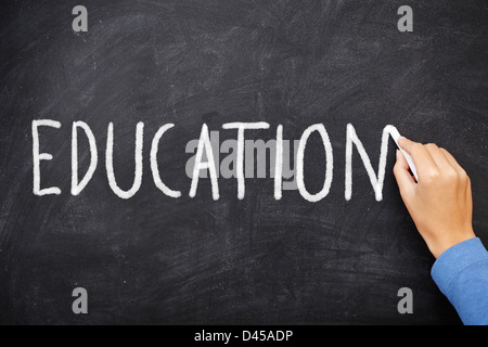 Education blackboard. Education written on chalkboard. Hand writing with chalk on school black board Stock Photo