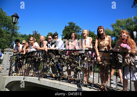 Young people on a Bridge with lock padlocks  in Bastejkalns-Park Stock Photo
