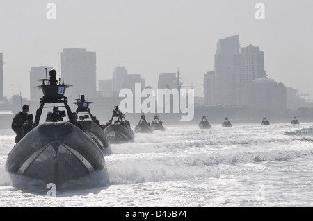 Rigid-hull inflatable boats carry Special Boat Team 12 Sailors and guests through San Diego Bay to an at-sea change of command.