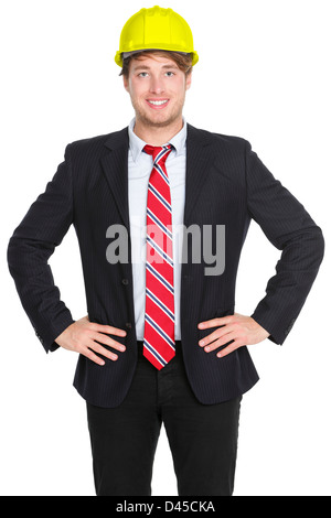 Portrait of confident young male engineer or architect in suit wearing helmet isolated on white background Stock Photo