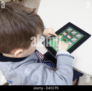 Small boy using an Apple iPad Stock Photo