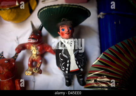 A mariachi paper mache doll and a red devil are displayed in a Mexican folk-art workshop. Stock Photo