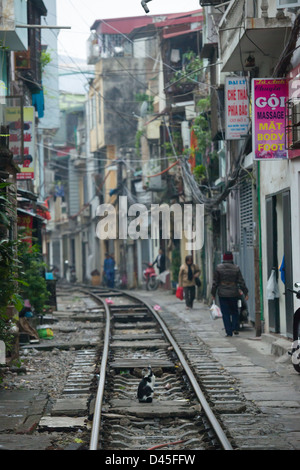 Railway track running through a narrow street of houses, Hanoi, Vietnam Stock Photo