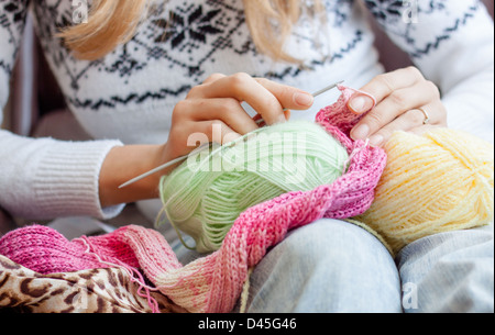 knitting woman , colorful, skein,  hobby, craft,  knit, knitting, hands,needles, pink yarn green, yellow, skeins, knitted ,scarf Stock Photo