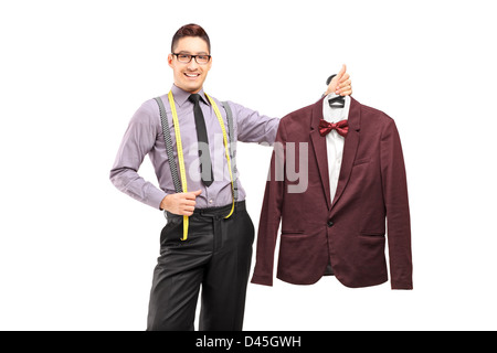 Male fashion designer holding a suit on a hanger, isolated on white background Stock Photo