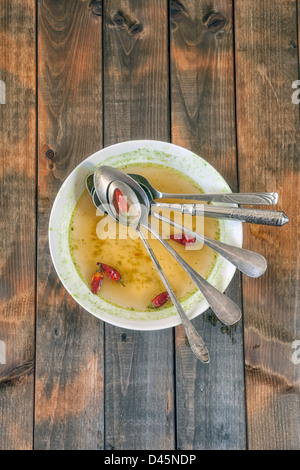 soup plate with hot chillies and five spoons Stock Photo
