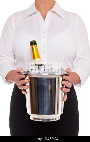 Waitress holding an ice bucket with a bottle of Champagne in it, isolated on a white background. Stock Photo