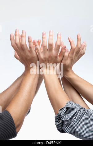 businessmen's hands gethered up together in the air as if holding something