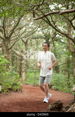 middle age man jogging in nature Stock Photo