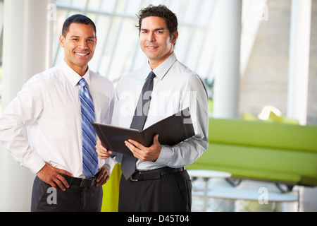 Businessmen Having Informal Meeting In Modern Office Stock Photo