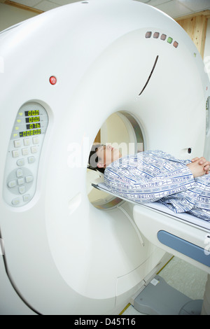 a patient going through a CT scanner Stock Photo