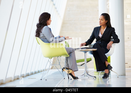 Two Businesswomen Meeting Around Table In Modern Office Stock Photo - Alamy