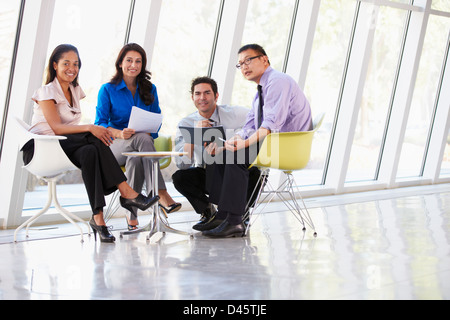 Businesspeople Having Meeting Around Table In Modern Office Stock Photo