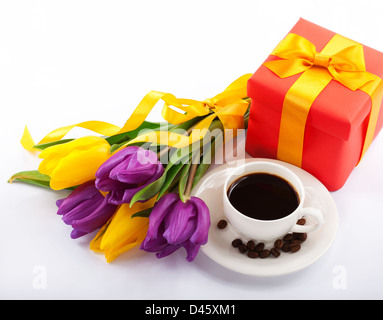 Flowers and red gift box. Cup of coffee Close-up. Stock Photo