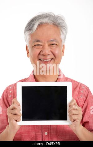Studio Shot Of Chinese Senior Man Holding Digital Tablet Stock Photo