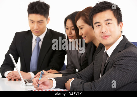 Studio Shot Of Chinese Businesspeople Having Meeting Stock Photo