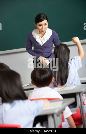 Teacher With Students In Chinese School Classroom Stock Photo