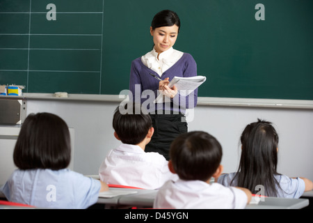 Teacher With Students In Chinese School Classroom Stock Photo