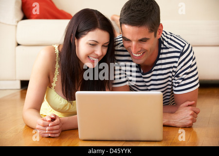 Couple Using Laptop At Home Stock Photo