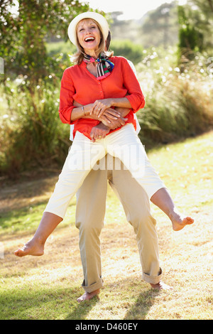 Senior Couple Having Fun Together In Garden Stock Photo