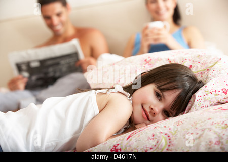 Family Relaxing In Bed Together Stock Photo