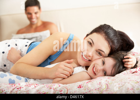 Family Relaxing In Bed Together Stock Photo