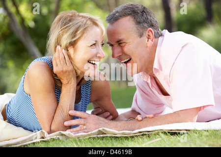 Senior Couple Relaxing In Summer Garden Stock Photo
