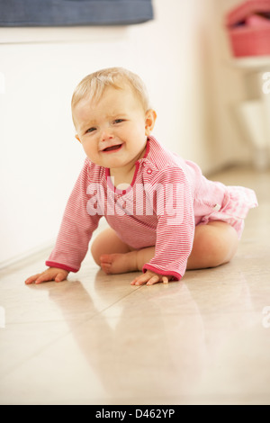 Unhappy Baby Girl Sitting On Floor Crying Stock Photo