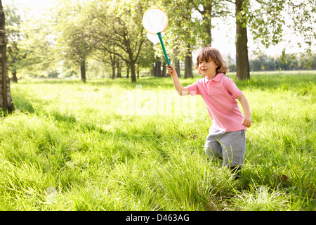 Young Boy In Field With Insect Net Stock Photo