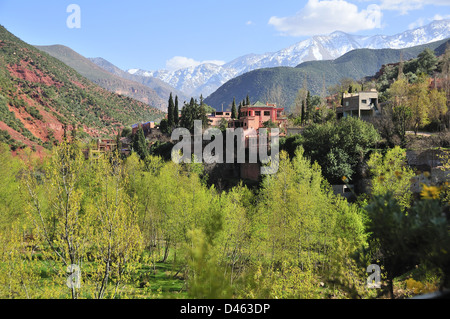 View of traditional Moroccan villages driving up the Ourika Valley towards Setti Fatma, with views of the snow covered High Atlas Mountains Morocco Stock Photo