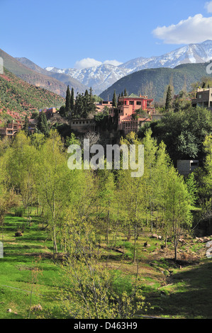 View of traditional Moroccan villages driving up the Ourika Valley towards Setti Fatma, with views of the snow covered High Atlas Mountains Morocco Stock Photo