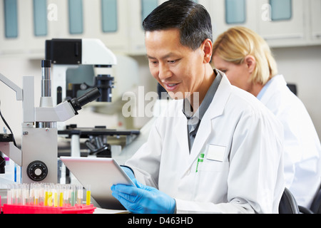 Male Scientist Using Tablet Computer In Laboratory Stock Photo