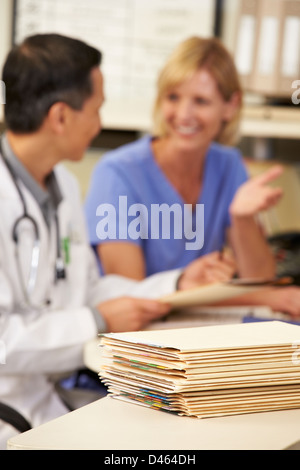 Patient Records On Desk At Nurses Station Stock Photo