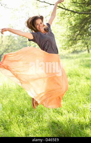 Woman Jumping In Summer Field Stock Photo
