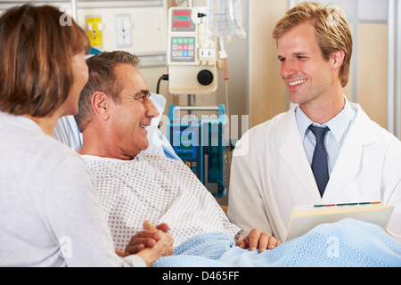 Doctor Talking To Couple On Ward Stock Photo