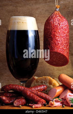 Still life with traditional sausages and glass of dark beer Stock Photo