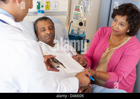 Doctor Explaining Consent Form To Senior Patient Stock Photo