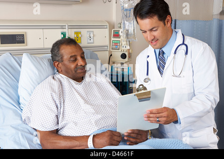 Doctor Explaining Consent Form To Senior Patient Stock Photo