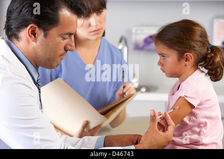Doctor Giving Child Injection In Doctor's Office Stock Photo