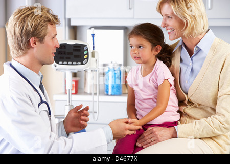 Mother And Child Visiting Doctor's Office Stock Photo