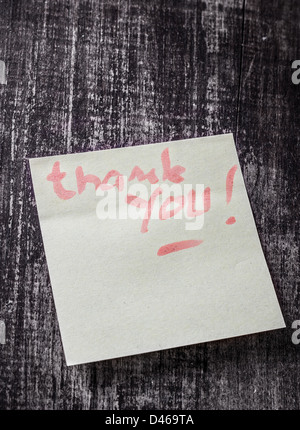 Thank you written on a post it note. Stock Photo