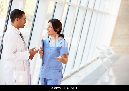 Medical Staff Having Discussion In Modern Hospital Corridor Stock Photo ...