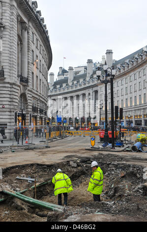Regent Street, London, UK. 6th March 2013. A large section of the road is exposed as workmen repair the water main that burst three days ago on the 3rd of March. Workmen are still repairing the broken water main on Regent Street at the junction with Vigo Street. Regent Street is still closed between Conduit Street and Piccadilly Circus. Credit:  Matthew Chattle / Alamy Live News Stock Photo