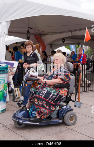 Older disabled woman on a mobility scooter. Stock Photo